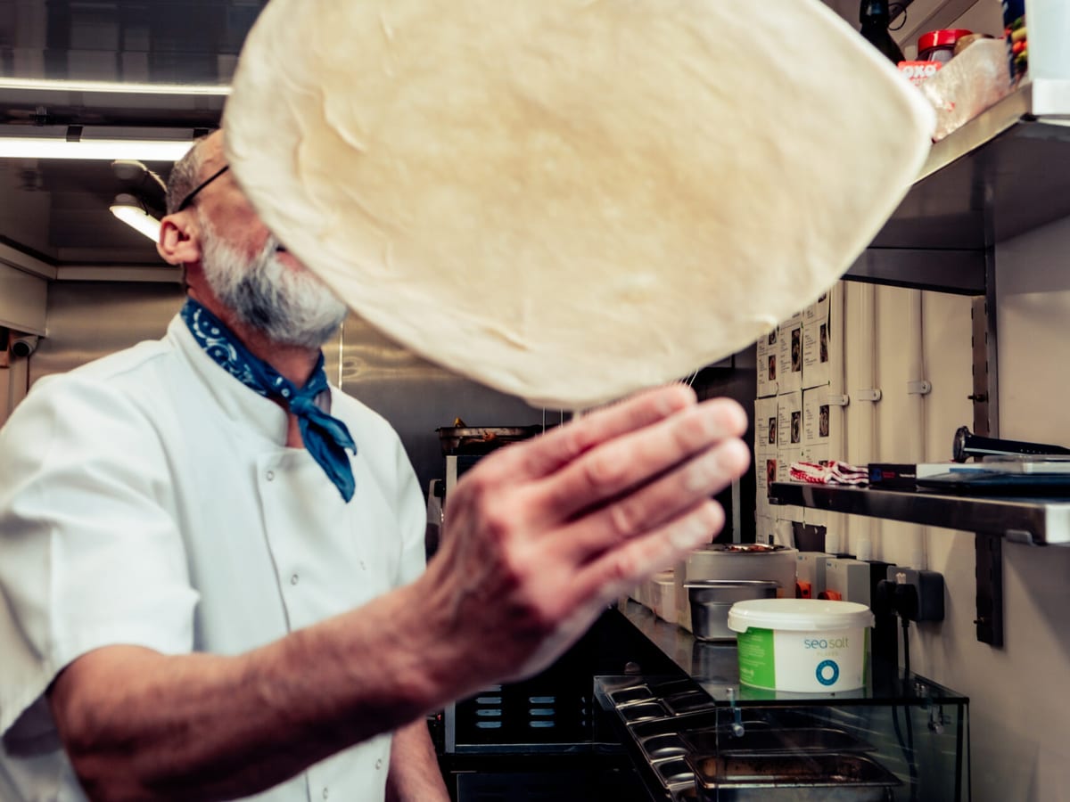 Pizza being prepared at Brew and Bones